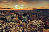 Woman looks out over Grand Canyon at sunset, Grand Canyon National Park, Arizona, USA, North America