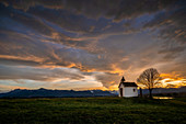 The chapel on the Riegsee in front of a dramatic evening sky, Aidling, Murnau, Bavaria, Germany