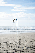 Shower in a deserted beach in winter, Forte die Marmi, Tuscany, Italy