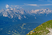 Woman hiking up to Soiernspitze, Wetterstein in the background, Soiernspitze, Karwendel, Upper Bavaria, Bavaria, Germany