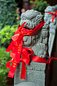 Red prayer ribbons in the courtyard of the Jade Buddha Temple, a Buddhist temple in Shanghai, China.