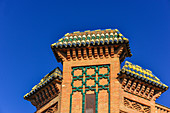 Ornately decorated roof with colored roof tiles against a deep blue sky, Seville, Andalusia, Spain