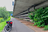 Touring bike below the motorway bridge on the Saar, near Saarbrücken, Germany