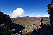 In front of me lies the desert-like plateau of Plaine des Sables and in the background the Piton de la Fournaise.