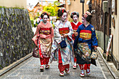 Women dressed in traditional geisha dress, Kyoto, Japan