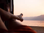 A person enjoying the view from inside a camper van at Blowering Lake and Dam.