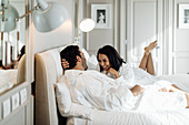 Couple laughing and relaxing in suite