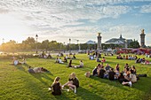 France, Paris, Esplanade des Invalides, picnic on summer evenings and the Grand Palais in the background