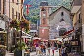 France, Savoie, Moutiers, Tarentaise valley, market day on the St Pierre square and the bell tower of the clock of the church Saint Pierre from the street Grande Rue