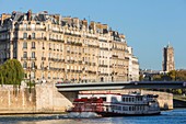 France, Paris, area listed as World Heritage by UNESCO, Quai de la Tournelle, a boat in Aube passes in front of the Ile de la Cite and the Tour Saint Jacques