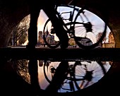 France, Paris, Paris, area listed as World Heritage by UNESCO, a cyclist walking under a bridge behind Notre Dame