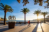 France, Pyrenees Orientales, Cote Vermeille, hiking from Banyuls sur Mer to Cerbere on the coastal path, Banyuls sur Mer, esplanade along the Central Beach and the sculpture of the sardane dancers (Catalane traditional dance) by the artist Pat Rowland