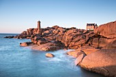 France, Cotes d'Armor, Perros Guirec, the lighthouse of Ploumanac'h or lighthouse Mean Ruz and the coast of Granit Rose at sunset