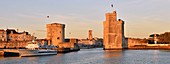 France, Charente-Maritime, La Rochelle, Chain tower (tour de la Chaine) and Saint Nicolas tower(tour Saint-Nicolas) protect the entrance to the Old Port and the St Sauveur church at the center