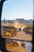 Off road vehicle driving through Valley of the Gods,Utah,US