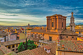 Rooftops landscape panorama with low-rise buildings and  Basilica di Sant'Andrea delle Fratte at golden hour elevated view, Rome, Lazio, Italy, Europe