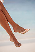 Woman's legs at tropical beach