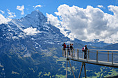 Several people stand on Cliff Walk with a view of Eiger, Tissot Cliff Walk, First, Grindelwald, Bernese Oberland, UNESCO World Heritage Site Swiss Alps Jungfrau-Aletsch, Bernese Alps, Bern, Switzerland