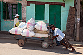 Malagasy people push cart, Madagascar, Africa