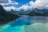 Aerial view of sailboats at anchor in Opunohu Bay with Mount Tohivea in the distance, Moorea, Windward Islands, French Polynesia, South Pacific