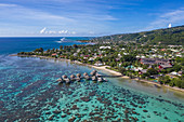 Aerial view of overwater bungalows of the Tahiti Ia Ora Beach Resort (managed by Sofitel) with Moorea Island in the distance, near Papeete, Tahiti, Windward Islands, French Polynesia, South Pacific