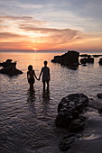 Silhouette of young couple holding hands on Ong Lang Beach at sunset, Ong Lang, Phu Quoc Island, Kien Giang, Vietnam, Asia