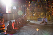 Guide from river cruise ship prays with Buddhist monks in the temple, Preah Prosop, Mekong River, Kandal, Cambodia, Asia