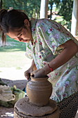 Woman makes ceramic vase in a pottery village, Andong Russei, Kampong Chhnang, Cambodia, Asia