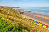View of colourful beach huts on West Cliff Beach, Whitby, North Yorkshire, England, United Kingdom, Europe