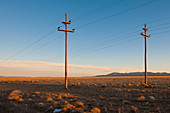 Power lines in desert landscape.