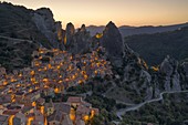 aerial view taken by drone of the village of Castelmezzano during a golden hours in summer time, with the Lucanian Dolomites in the background, municipality of Castelmezzano, Potenza province, Basilicata district, southern Italy, Europe