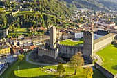 Aerial view of the medieval Bellinzona castles, Unesco World Heritage site, in autumn at sunset. Canton Ticino, Switzerland.