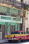 Red and yellow classic car in Havana, Cuba