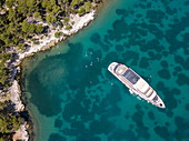 Aerial view of cruise ship in pristine bay at a swim stop for passengers, near Rab, Primorje-Gorski Kotar, Croatia, Europe