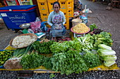 Woman sells fruits and vegetables at the morning market, Luang Prabang, Luang Prabang Province, Laos, Asia