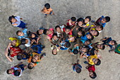 Aerial view of school children in front of ATCA School in Donemisay Village supported by funds provided by Lernidee Adventure Travel, Ban Pak Tha, Pak Tha District, Bokeo Province, Laos, Asia