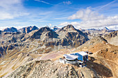 Aerial by drone of cable car station on top of the rocky peak of Piz Nair, Engadine, canton of Graubunden, Switzerland, Europe