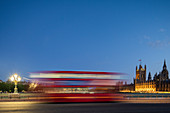 A red London bus goes past in a blur across Westminster Bridge, London, England, United Kingdom, Europe