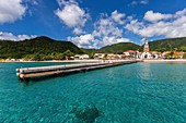 Martinique, view on the village of Anses d'Arlets, pontoon and church Saint-Henri on the beach, Bourg des Anses d'Arlets on the seafront