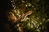 little boy stands in front of the Christmas tree, Christmas, family