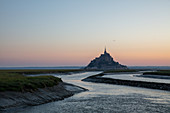 Morning view of the rocky island of Mont Saint Michel with the monastery of the same name, Normandy, France.