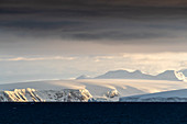 Sunrise on snow-covered mountains and tidewater glaciers in Mikkelsen Harbor, Trinity Island, Antarctica, Polar Regions