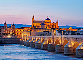View over Roman Bridge of Cordoba and Guadalquivir River towards the Mosque Cathedral, dusk, UNESCO World Heritage Site, Cordoba, Andalusia, Spain, Europe