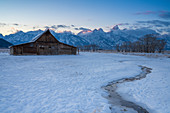 First light on Teton Range at Moulton Barn in the snow, Grand Teton National Park, Wyoming, United States of America, North America