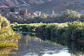 Sunsrise on a river with a kasbah's ruin reflection, Draa Valley, Morocco, North Africa, Africa