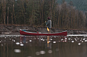Canada, British Columbia, Man with canoe at Squamish River