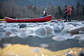 Canada, British Columbia, Friends with canoe resting at Squamish River