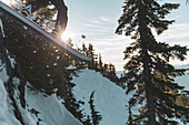 Canada, British Columbia, Squamish, Man jumping on snowboard