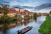 Germany, Bavaria, Bamberg, Boats moored in river with townhouses in background