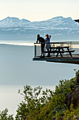 Young couple on terrace, from Fagernesfjell you have a great view of the Ofotfjord and, Narvik, Norway